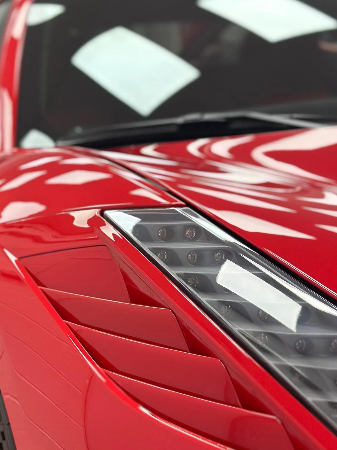 Red Ferrari headlight and sculpted front wing vents