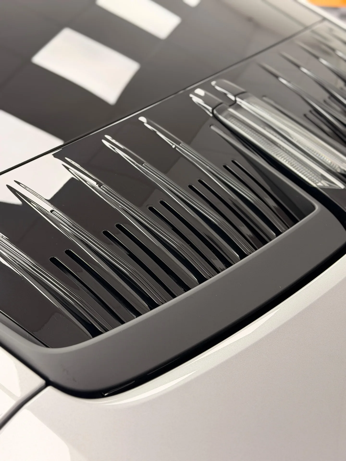 Silver Porsche 911 rear engine-lid grille detail
